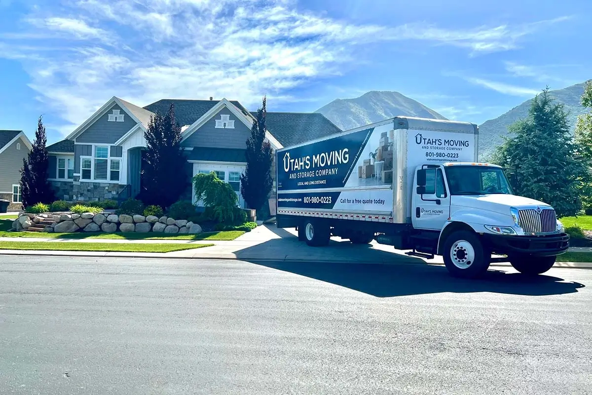 Utah's Moving & Storage moving truck parked outside a Utah home with mountain views